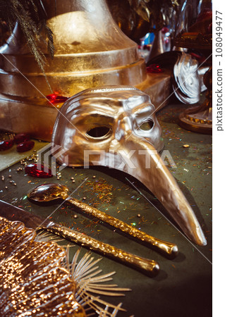 Gold Venetian mask on a table Gold Venetian mask on a table 108049477