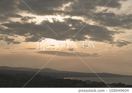 Abstract background sky Dawn Sunset Contrast dark shadow bright cloud sun orange silhouette above the mountains near the sea Abstract background sky Dawn Sunset Contrast dark shadow bright cloud sun orange silhouette above the mountains near the sea 108049604