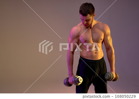 strong muscular young man holding dumb-bells 108050229
