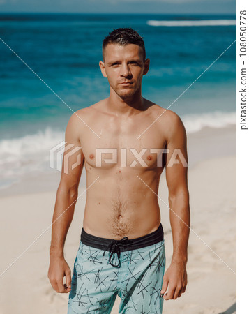 Portrait of attractive young man on a sandy beach. Caucasian man looking at camera Portrait of attractive young man on a sandy beach. Caucasian man looking at camera 108050778