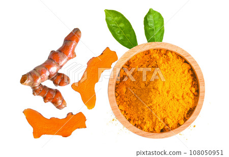 curcuma powder in a bowl and root on white background curcuma powder in a bowl and root on white background 108050951
