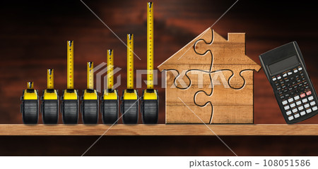 Tape Measures Forming a Bar Graph and a Wooden House 108051586