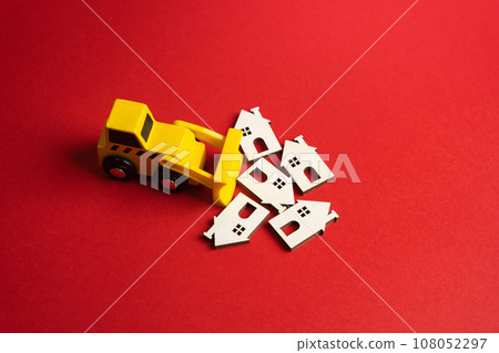 The bulldozer demolishes the figurines of the houses. Preservation and renewal. Pave the way for fresh perspectives. Potential for creative renewal. Clear the area for city development. The bulldozer demolishes the figurines of the houses. Preservation and renewal. Pave the way for fresh perspectives. Potential for creative renewal. Clear the area for city development. 108052297