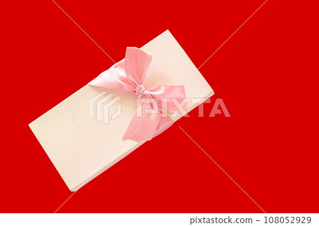 ribbon roll pink gift box on red background ribbon roll pink gift box on red background 108052929