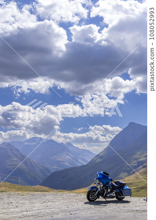 Motorbike on Route des Grandes Alpes near Col de l'Iseran, Savoy, France 108052993