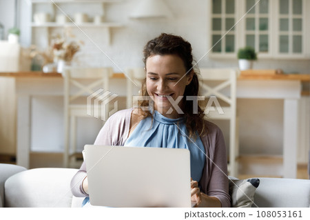 Happy young freelance worker woman working at laptop computer 108053161