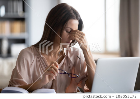Woman takes off glasses suffers from eyestrain dry eyes 108053172