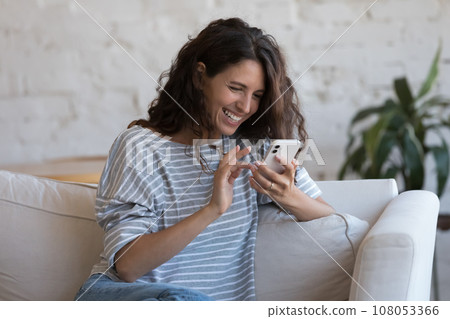 Cheerful smartphone user woman chatting online with happy smile 108053366