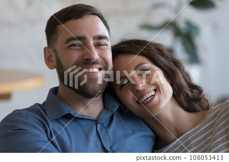Happy attractive adult couple in love indoor close up portrait Happy attractive adult couple in love indoor close up portrait 108053413