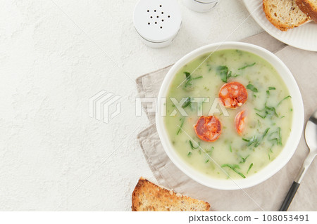 Portuguese style soup Caldo Verde with bread on white table.Flat lay copy space 108053491