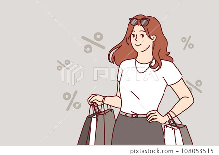 Woman shopaholic returns from store with packages and stands among percent symbols 108053515