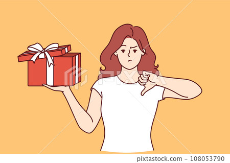 Woman with gift in hands is nervous and points finger down due to poor quality of present Woman with gift in hands is nervous and points finger down due to poor quality of present 108053790