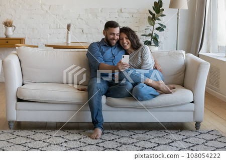 Joyful happy dating couple in love relaxing on home couch 108054222