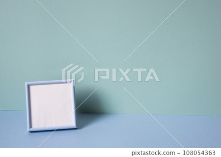 Blank picture frame on mint blue background. copy space 108054363