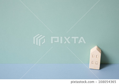 Miniature wood model house on mint blue background. rental, buy, real estate concept Miniature wood model house on mint blue background. rental, buy, real estate concept 108054365