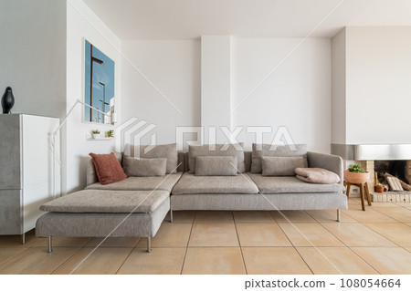Large grey couch with cushions and plaid in home apartment Large grey couch with cushions and plaid in home apartment 108054664