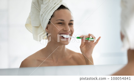 Smiling young woman clean teeth with toothbrush in bath 108054841