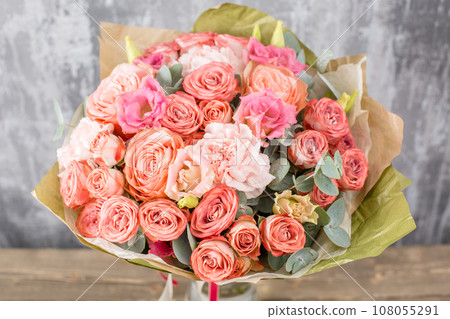 Floral shop concept. Small Beautiful bouquet of mixed flowers. Beautiful fresh cut bouquet. Flowers delivery Floral shop concept. Small Beautiful bouquet of mixed flowers. Beautiful fresh cut bouquet. Flowers delivery 108055291