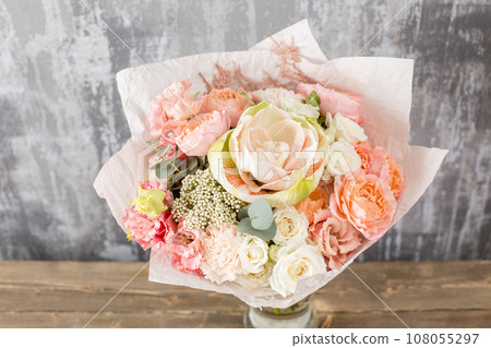 Floral shop concept. Small Beautiful bouquet of mixed flowers. Beautiful fresh cut bouquet. Flowers delivery 108055297