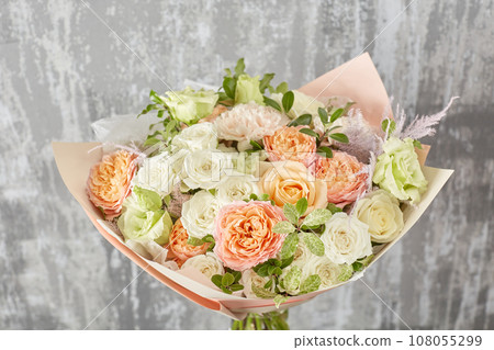 Floral shop concept. Small Beautiful bouquet of mixed flowers. Beautiful fresh cut bouquet. Flowers delivery Floral shop concept. Small Beautiful bouquet of mixed flowers. Beautiful fresh cut bouquet. Flowers delivery 108055299