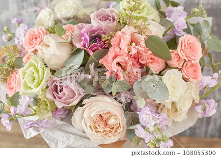 Small Beautiful bouquet of mixed flowers in woman hand. Floral shop concept . Beautiful fresh cut bouquet. Flowers delivery Small Beautiful bouquet of mixed flowers in woman hand. Floral shop concept . Beautiful fresh cut bouquet. Flowers delivery 108055300