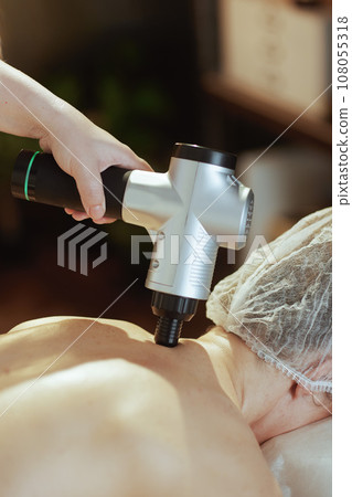 Medical massage therapist in spa salon massaging clients neck 108055318