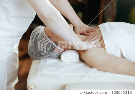 Massage therapist in spa salon massaging clients chest 108055319