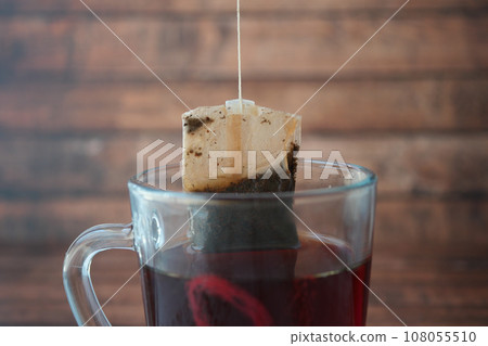 green tea and tea bag on table, close up. 108055510