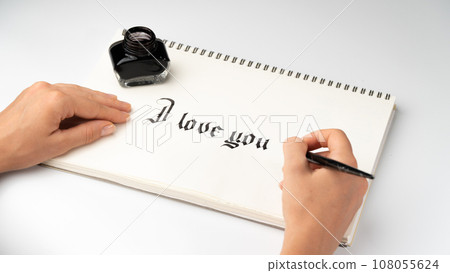 Women's hands write I love you fountain pen for calligraphy 108055624