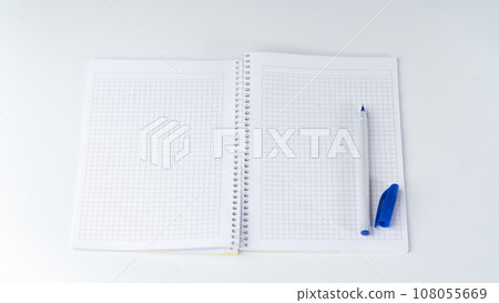 Open notebook in a cage, on the right side there is a pen with an open cap Open notebook in a cage, on the right side there is a pen with an open cap 108055669