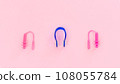 Swimmer set - earplugs and nose clip on pink background close-up 108055784