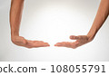 Women's hands insulated hold a large object on a white background 108055791