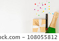 New Year's set - a gift, champagne and a cracker on a white background with a place for text 108055812