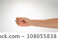 Hand woman gesture fingers clenched into a ring holding a cylindrical object 108055838