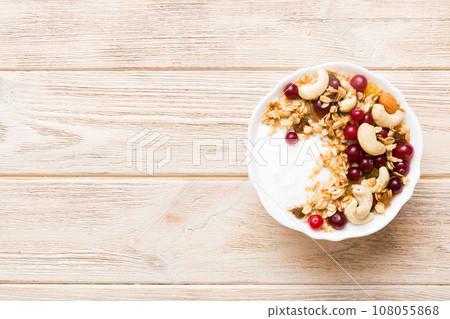 Healthy breakfast food with granola, yogurt, fruits and nuts. Dessert parfait with dried fruits for breakfast 108055868