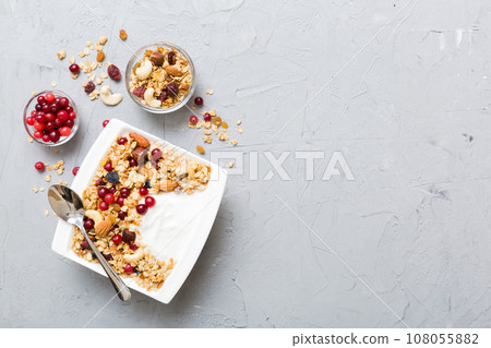Healthy breakfast food with granola, yogurt, fruits and nuts. Dessert parfait with dried fruits for breakfast 108055882