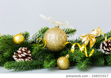 New Year Christmas tree toy, branches of a christmas tree, New Year decorations on a colored background 108055917