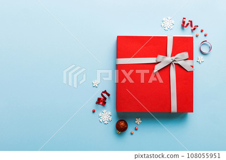 Top view Flat lay Christmas decorations and gift box on colored background with copy space. Christmas or Happy New Year composition 108055951