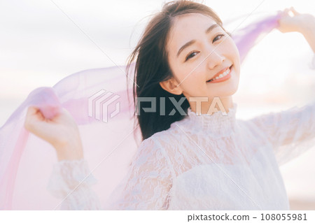 Woman portrait against sunset background 108055981