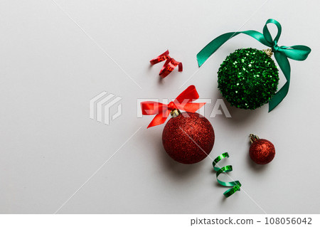 Christmas ball on colored background. decoration bauble with ribbon bow with copy space Christmas ball on colored background. decoration bauble with ribbon bow with copy space 108056042