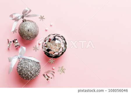 Christmas ball on colored background. decoration bauble with ribbon bow with copy space Christmas ball on colored background. decoration bauble with ribbon bow with copy space 108056046