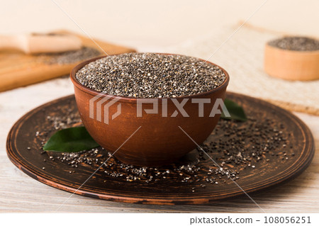 Chia seeds in bowl and spoon on colored background. Healthy Salvia hispanica in small bowl. Healthy superfood 108056251