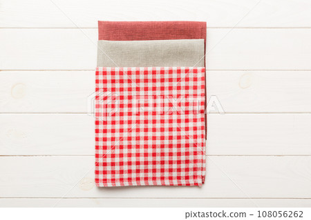 top view with red empty kitchen napkin isolated on table background. Folded cloth for mockup with copy space, Flat lay. Minimal style 108056262