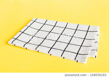top view with white empty kitchen napkin isolated on table background. Folded cloth for mockup with copy space, Flat lay. Minimal style 108056283