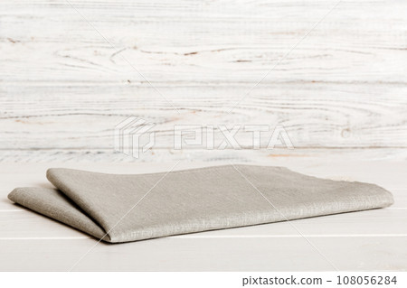 top view with gray kitchen napkin isolated on table background. Folded cloth for mockup with copy space, Flat lay. Minimal style 108056284