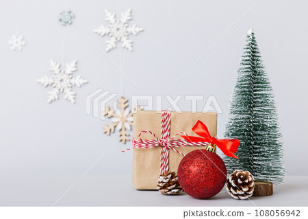 Christmas composition. Gifts, small tree, branches and craft DIY decorations on white background. New year concept. Christmas home decoration Flat lay, top view, copy space Christmas composition. Gifts, small tree, branches and craft DIY decorations on white background. New year concept. Christmas home decoration Flat lay, top view, copy space 108056942