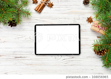 Digital tablet mock up with rustic Christmas wooden background decorations for app presentation. top view with copy space 108056965