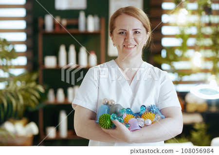 smiling female medical massage therapist in spa salon 108056984