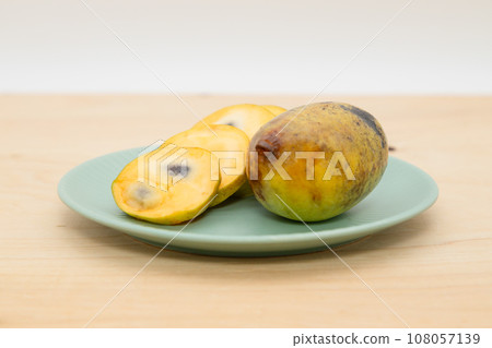 Pawpaw - fruit cut and placed on a plate 108057139
