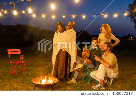 Young hipster people having fun to music dining and drinking together in campsite - Travel vacation 108057217